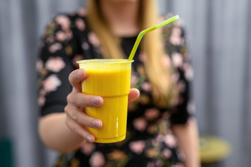 Woman drinking pineapple smoothie