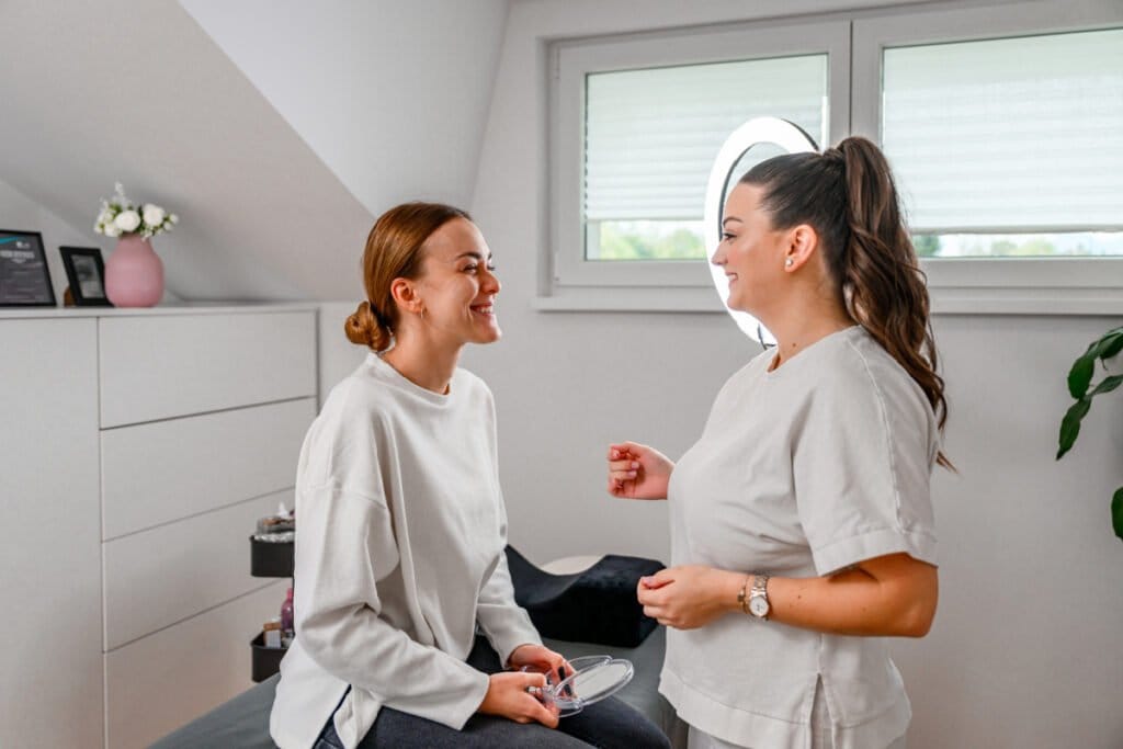 Patient talking to her aesthetician about goals for facial filler injections