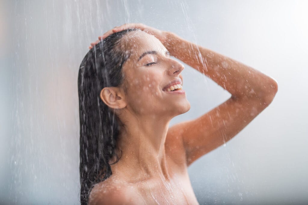 Woman smiling as she showers