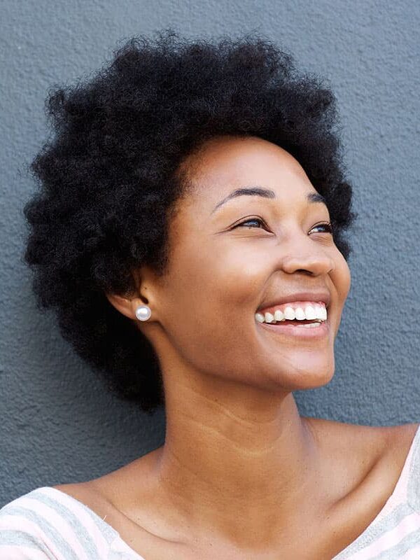 Smiling woman with graceful neck contours